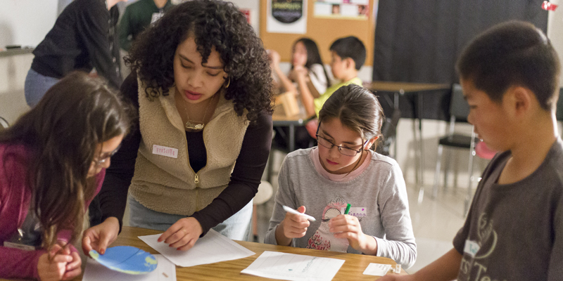 Teacher helping with student project